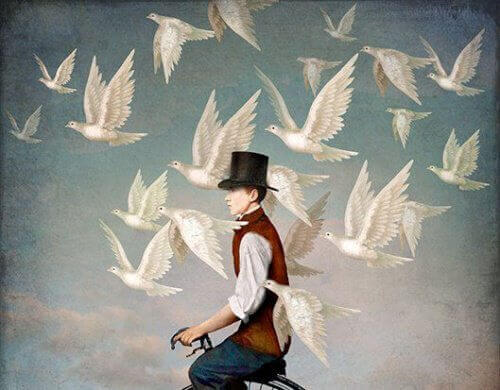 Man på cykel med vita fåglar runtomkring