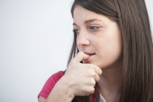 kvinna som biter på nagel