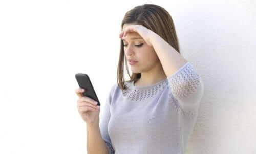Kvinna läser meddelanden på sin mobil