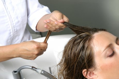 kvinna får håret tvättat och masserat