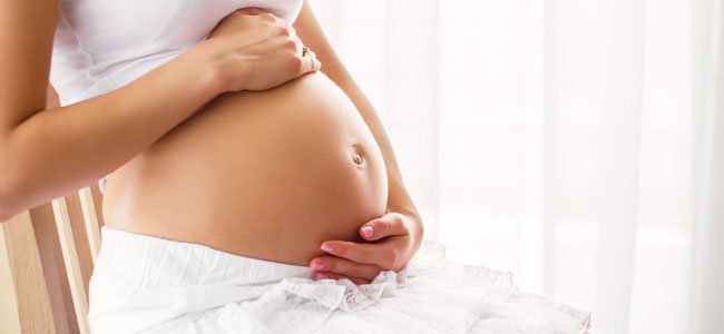 Kvinna som är gravid.