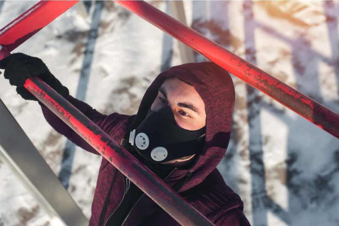 Man med ansiktsmask för höjdträning
